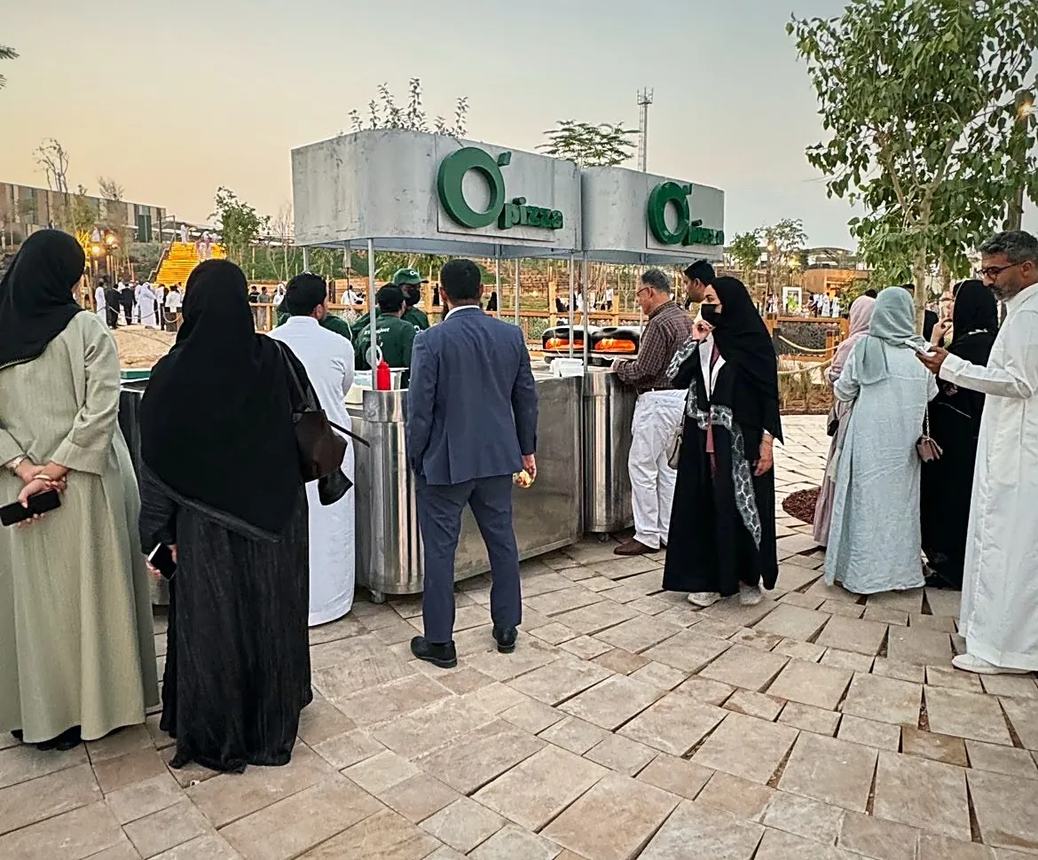 ضيوف حول محطات O’Pizza في إحدى الفعاليات
